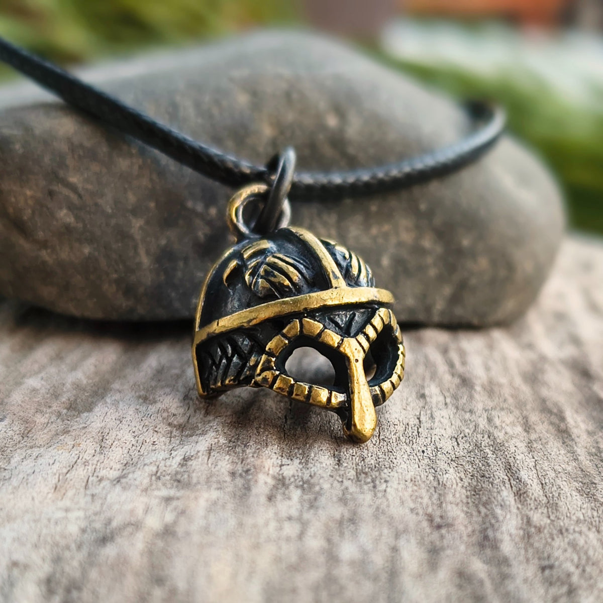 Hand-cast brass Viking helmet pendant featuring two ravens, 18 × 12 mm, with adjustable cord, inspired by Norse mythology.