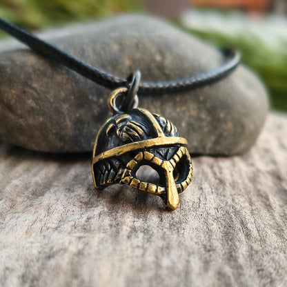 Hand-cast brass Viking helmet pendant featuring two ravens, 18 × 12 mm, with adjustable cord, inspired by Norse mythology.